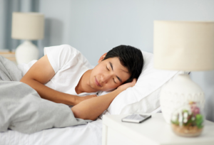 man sleeping with blanket for additional warmth