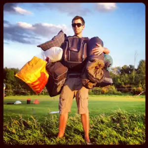 man holding several emergency sleeping bags